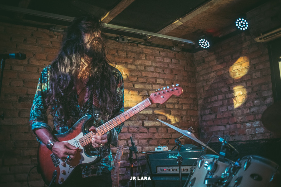 Nicolas performing on stage with a Stratocaster