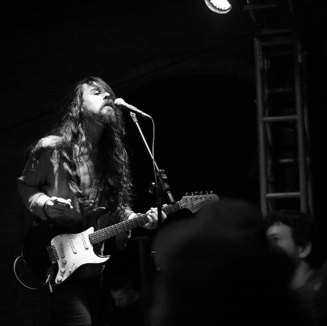 Nicolas singing and playing guitar live