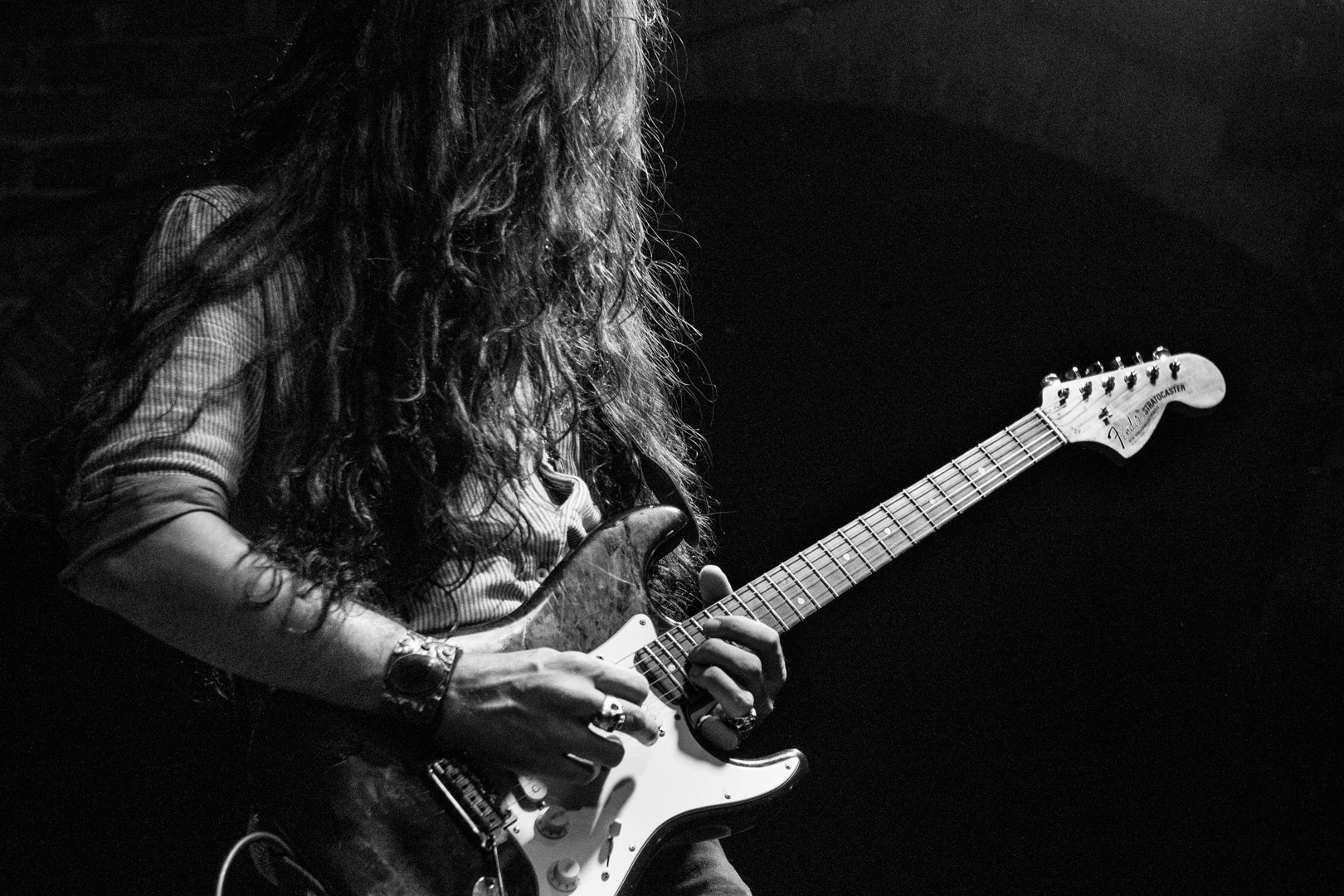 Nicolas playing guitar live in black and white