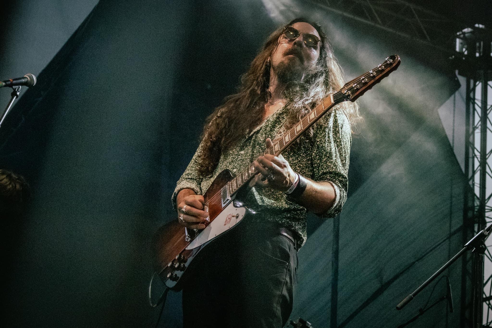 Nicolas playing guitar live at a festival